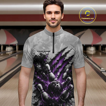 Front view of a male model wearing a gray bowling quarter zip shirt with a dramatic purple bowling ball and pins graphic accented by claw-mark artwork in a bowling lane.
