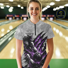Load image into Gallery viewer, Front view of a female model wearing a gray bowling quarter zip shirt featuring a dramatic purple bowling ball and pins graphic with claw-mark artwork in a bowling lane.