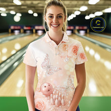 Load image into Gallery viewer, Female model in a bowling alley wearing a bowling polo shirt with pastel glitter butterfly artwork floating above bowling pins and a bowling ball.