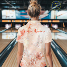 Load image into Gallery viewer, Back view of a female model at a bowling lane wearing a polo shirt showcasing pastel butterflies above bowling pins and bowling ball graphics.