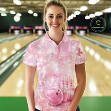 Load image into Gallery viewer, Female model in a bowling venue wearing a bowling polo shirt with sparkling butterfly artwork, diamond accents, bowling pins, and a bowling ball.