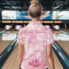 Load image into Gallery viewer, Back view of a female model in a bowling alley wearing a polo shirt showcasing pink glitter butterflies, diamonds, bowling pins, and bowling graphics.