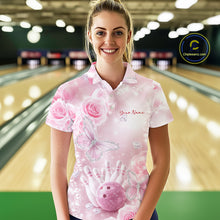 Load image into Gallery viewer, Female model wearing a bowling polo shirt in a bowling alley with pink glitter butterflies, floral rose accents, bowling pins, and a bowling ball.