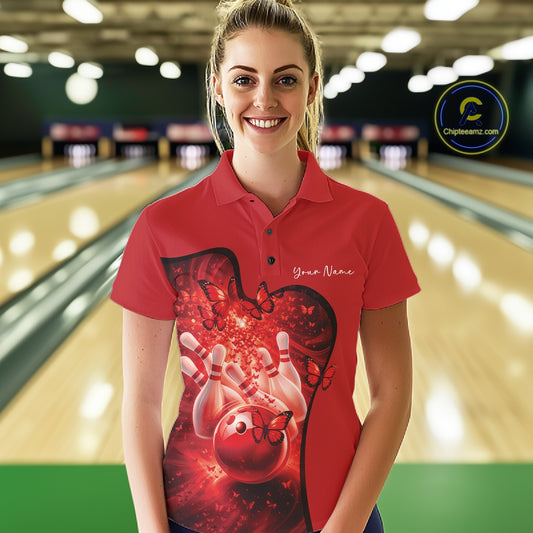 Female model wearing a red bowling polo shirt with butterfly accents and bowling-themed graphics at the bowling lane.
