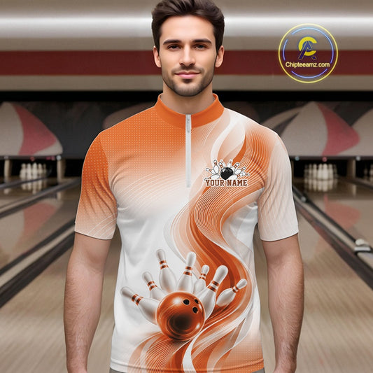Male model at the bowling lane wearing a white and orange bowling quarter-zip shirt with wave-inspired artwork and a bowling strike design