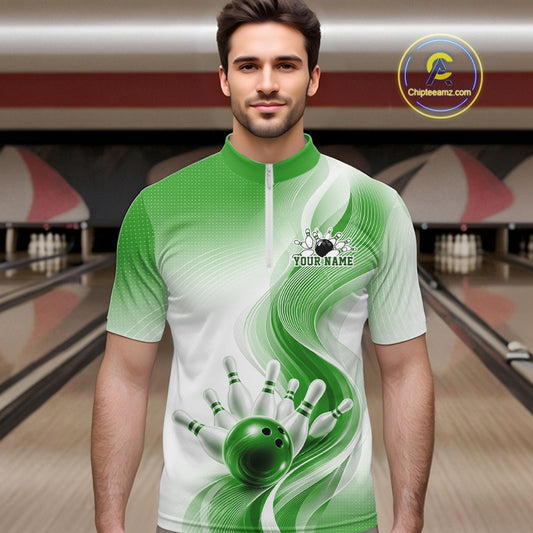 Male model in a white and green bowling quarter zip shirt with abstract flowing wave accents and glossy bowling strike graphics, front view at a bowling lane