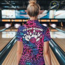 Load image into Gallery viewer, Back view of a woman standing at a bowling alley, wearing a gold, brown, and black leopard-print bowling polo with “Team Name” and bowling pins on the back.