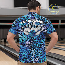 Load image into Gallery viewer, Back view of a man standing at a bowling alley, wearing a blue, teal, and black leopard-print bowling polo with “Team Name” and bowling pins on the back.
