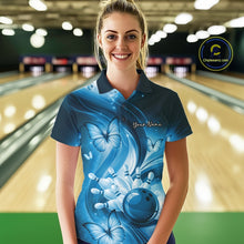 Load image into Gallery viewer, Female model wearing a blue bowling polo at the bowling lane with bowling ball and butterfly graphics.
