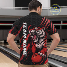 Load image into Gallery viewer, Male model wearing a black and red bowling quarter-zip shirt at a bowling lane featuring a roaring tiger holding a red bowling ball with matching claw-stripe artwork and a geometric background pattern.