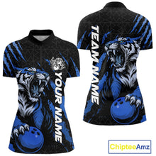 Load image into Gallery viewer, Front and back view of a black and mid blue women's bowling quarter-zip shirt showcasing a roaring tiger holding a mid blue bowling ball with matching claw-stripe artwork and a geometric background pattern.
