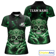 Load image into Gallery viewer, Front and back view of a black and green women’s bowling polo shirt showcasing a floral sugar skull above a bowling ball with Day of the Dead styling.