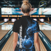 Load image into Gallery viewer, Back view of a female model in a bowling alley wearing a black bowling polo with a blue flaming skull, lightning, bowling pins, and a custom name.
