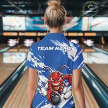 Load image into Gallery viewer, Back view of a female model in a bowling alley wearing a blue custom quarter zip bowling shirt with an aggressive crawfish bowling design and a distressed background.