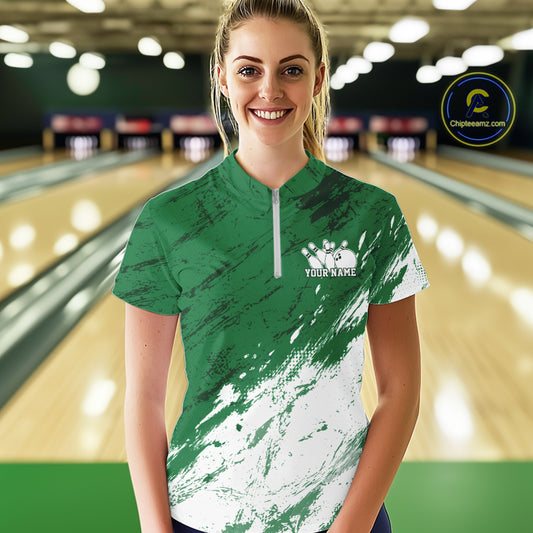 Woman wearing a green and white bowling shirt with a personalized name on a bowling alley background