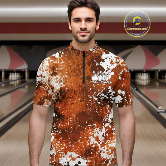 Man wearing a custom bowling shirt with splatter design in a bowling alley.