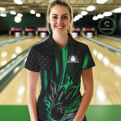 Female model wearing a black and green bowling polo shirt at a bowling lane showcasing patriotic bowling strike artwork with distressed flag styling.