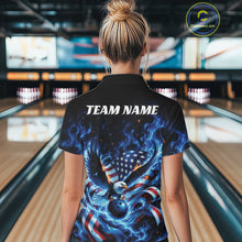 Load image into Gallery viewer, Back view female model in a bowling lane wearing a bowling polo shirt with flaming bald eagle, blue bowling ball, flag details, and blue flames.
