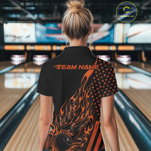 Load image into Gallery viewer, Back view of a female model in a bowling center wearing a black polo shirt featuring an orange flaming bowling ball and patriotic pin artwork.