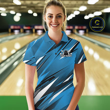 Load image into Gallery viewer, Woman wearing a blue bowling shirt with a logo and text on a bowling alley background