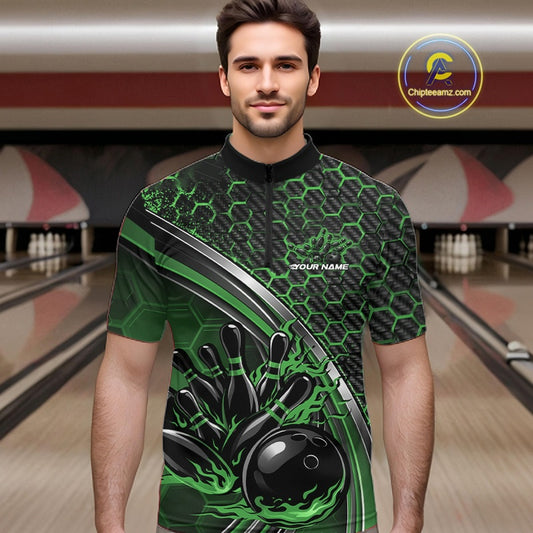 Male model in a bowling lane wearing a black and green quarter zip shirt with honeycomb graphics and a flaming bowling ball striking pins design.