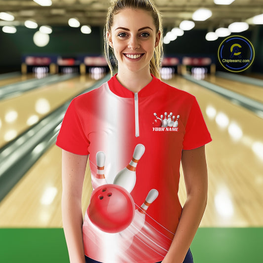 Female model front view at the bowling lane wearing a quarter zip shirt with bowling ball and pins flowing across a red gradient design.