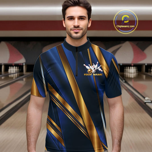 A man wearing a short-sleeve bowling shirt with a navy blue and gold abstract diagonal pattern, standing in front of a blurred bowling alley background. The shirt features a mock neck, a small white bowling pins graphic with the text 'YOUR NAME' on the left chest, and a circular 'Chiletaniz.