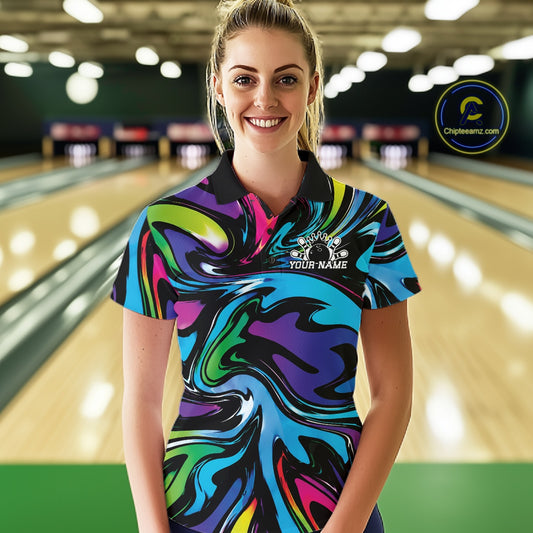 Woman wearing a colorful bowling shirt with a blurred bowling alley in the background