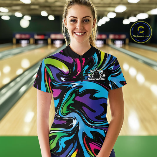 Person wearing a colorful bowling shirt with a design and text on a bowling alley background
