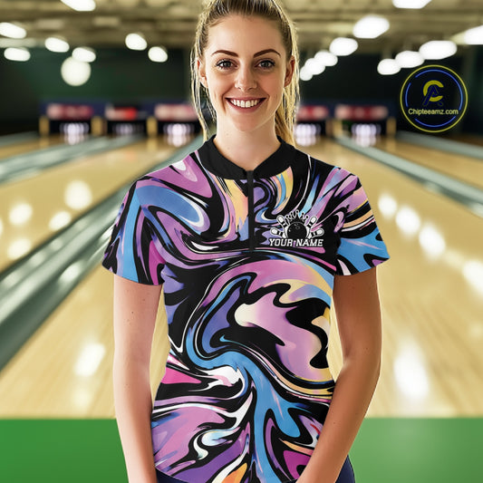 Woman wearing a colorful bowling shirt with a pattern on a bowling alley.