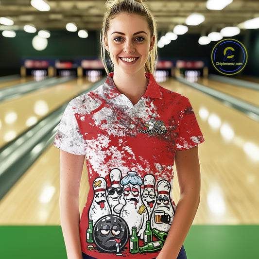 Female model front view in bowling lane wearing white polo featuring red and white splatter graphics, lively bowling pins and beer bottle illustration