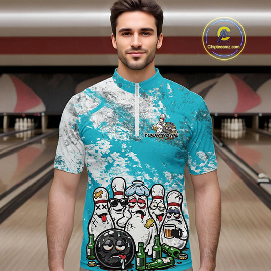Male model in a bowling lane wearing turquoise blue and white quarter zip shirt, front view showcasing grunge splatter background with playful bowling character graphics