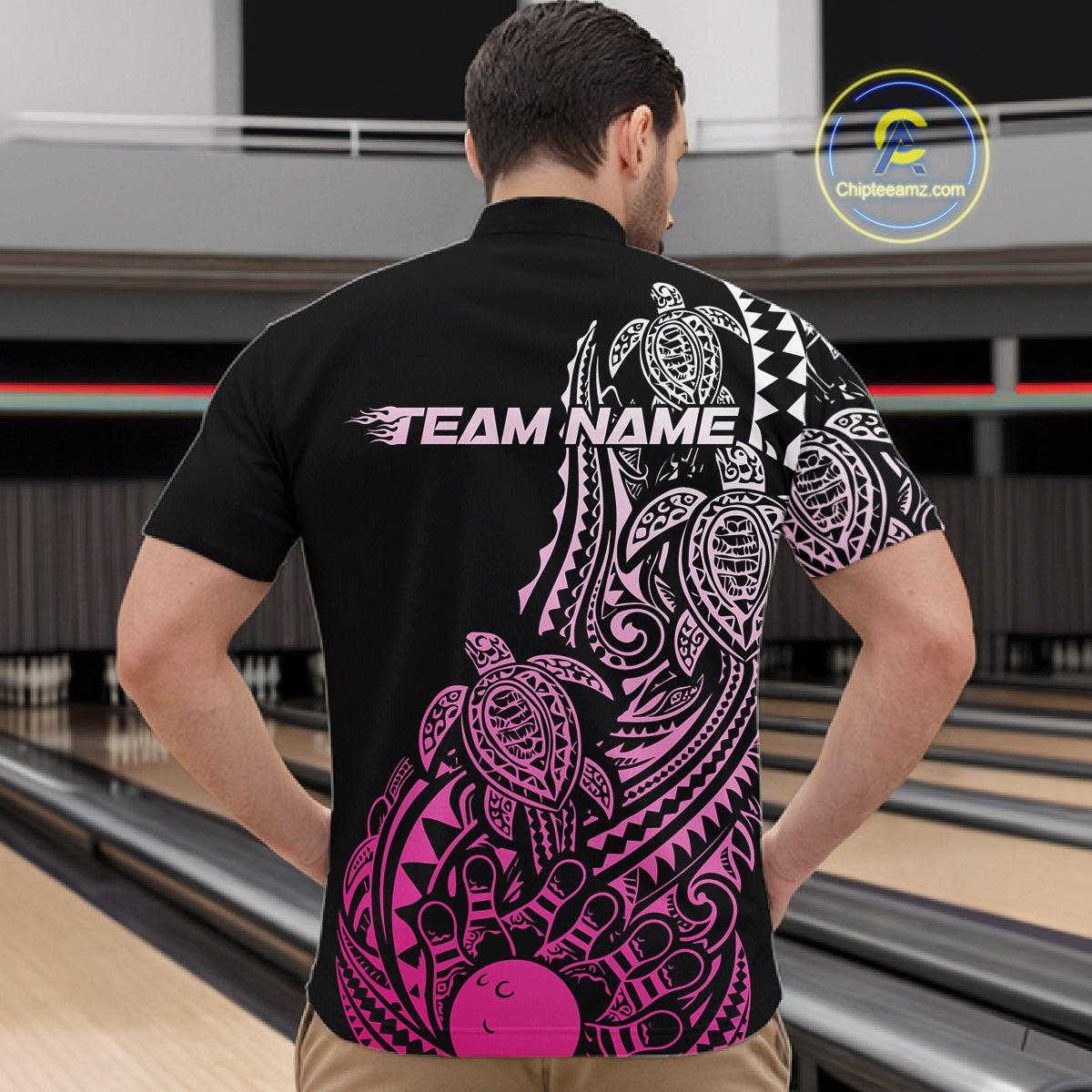 Front view of a male model in a black and pink bowling quarter-zip shirt featuring Polynesian-style bowling graphics.