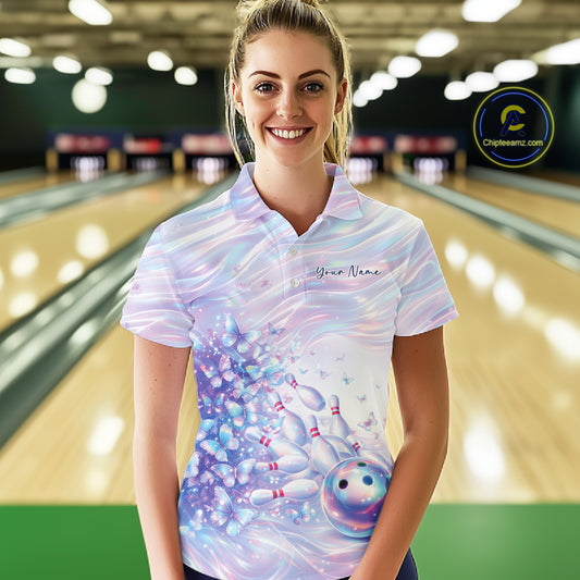 Front view of a female model in a bowling polo featuring pastel purple and pink holographic butterflies with vibrant bowling-themed artwork