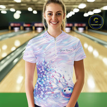 Load image into Gallery viewer, Female model wearing a bowling quarter zip with pastel purple and pink holographic butterfly graphics and bowling accents, front view at the bowling lane