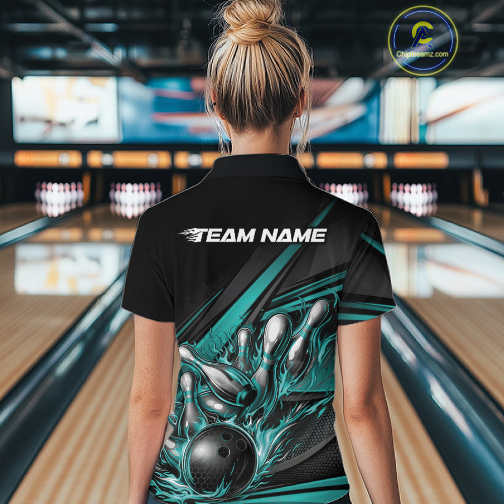 Back view of a female bowler wearing a black quarter-zip shirt, turquoise flame bowling ball and pins artwork combined with abstract stripe graphics.