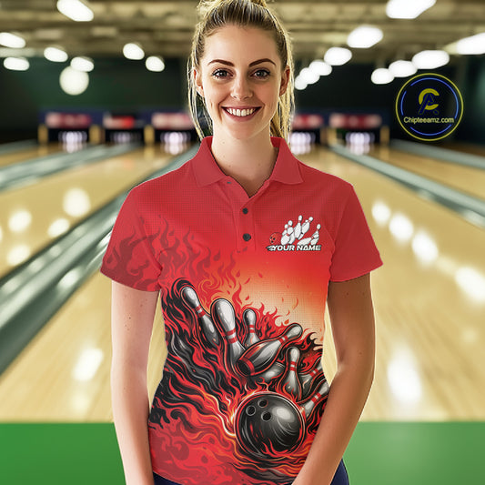 Female model wearing a red polo shirt in a bowling lane, front view featuring a flame bowling ball knocking down pins artwork