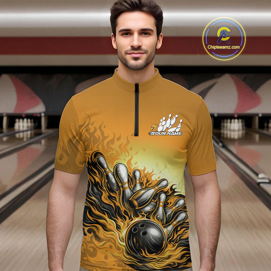Male model in a bowling lane wearing a yellow quarter-zip shirt, flame bowling ball hitting pins with energetic fire-style graphics.