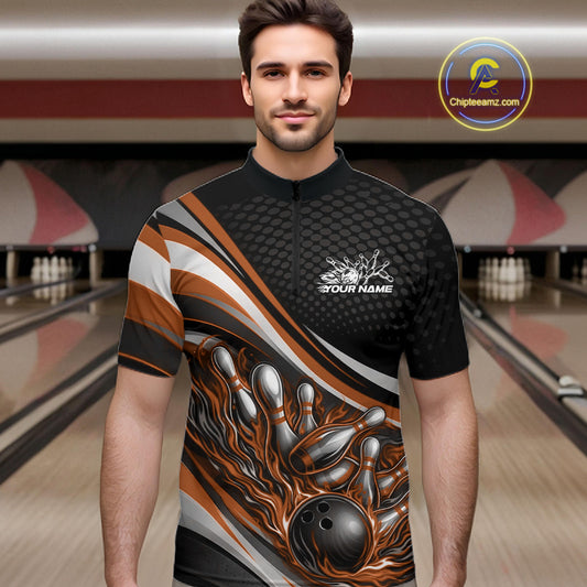 Male model at a bowling lane wearing a black and orange quarter-zip shirt, fiery bowling ball hitting pins with high-energy sports graphics.