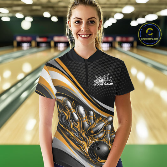 Front view female model wearing black and yellow quarter zip bowling shirt in bowling lane, flame bowling ball and pins artwork with dynamic lighting