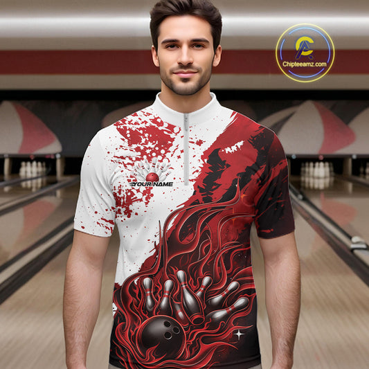 Front view of a male model in a bowling lane wearing a black quarter-zip shirt with red and white flame bowling ball and pins design and dynamic sports graphics.