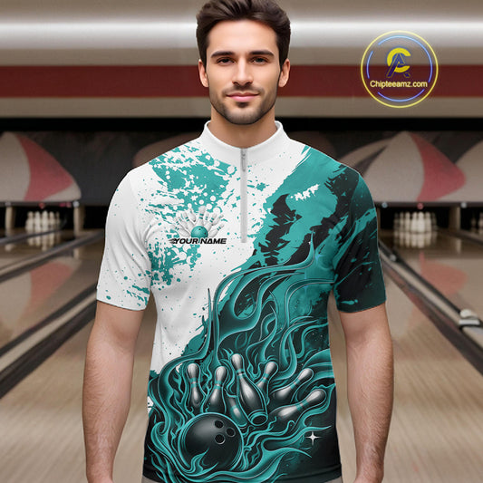 Front view of a male model in a bowling lane wearing a black quarter-zip shirt with turquoise blue and white flame bowling ball and pins illustration and dynamic bowling action scene.