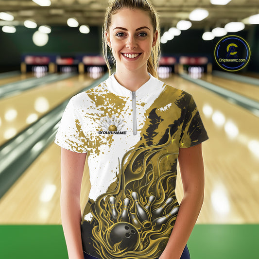 Front view of a female model in a bowling lane wearing a black, yellow and white flame bowling quarter-zip shirt with bold sporty bowling visuals.