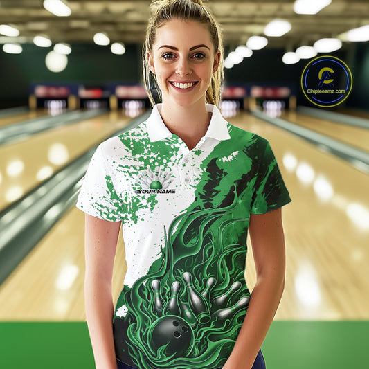 In bowling lane front view female model wearing bowling polo shirt, black green and white color scheme, flame bowling ball and pins artwork, dynamic sports environment