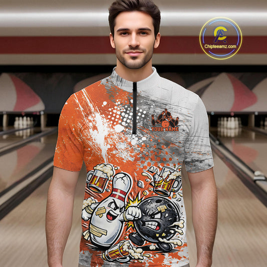 Front view of a male model in a bowling lane wearing an orange and white grunge splatter bowling quarter-zip shirt with funny cartoon bowling battle artwork.