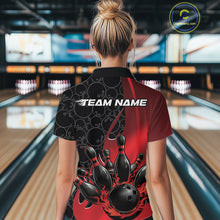 Load image into Gallery viewer, Back view of a female model in a bowling lane wearing a black and red polo shirt featuring flaming black bowling ball striking pins with energetic bowling graphics.