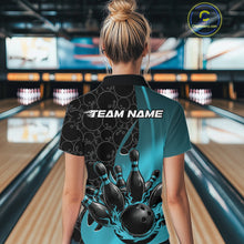 Load image into Gallery viewer, Back view of a female model in a bowling lane wearing a black and blue polo shirt featuring flaming black bowling ball striking pins with bold sports styling.