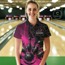 Load image into Gallery viewer, Front view of a female model in a bowling lane wearing a black and pink polo shirt with flaming black bowling ball striking pins and dynamic bowling graphics.