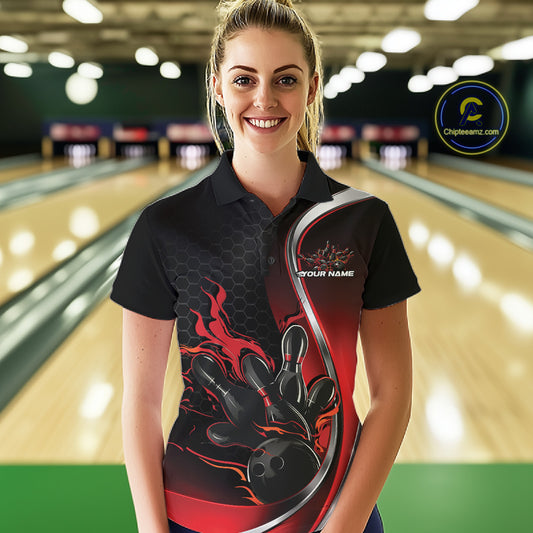 Female model front view at bowling lane wearing black and red polo shirt with flaming bowling ball hitting pins in powerful sports motion scene.