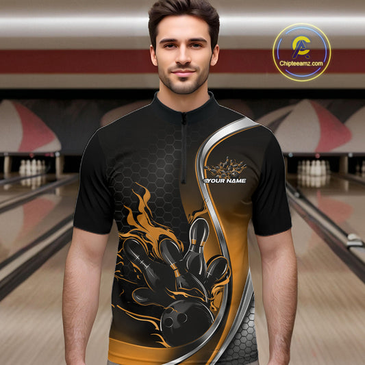 Male model front view inside bowling center wearing black and yellow quarter zip shirt featuring flaming bowling ball hitting pins graphics